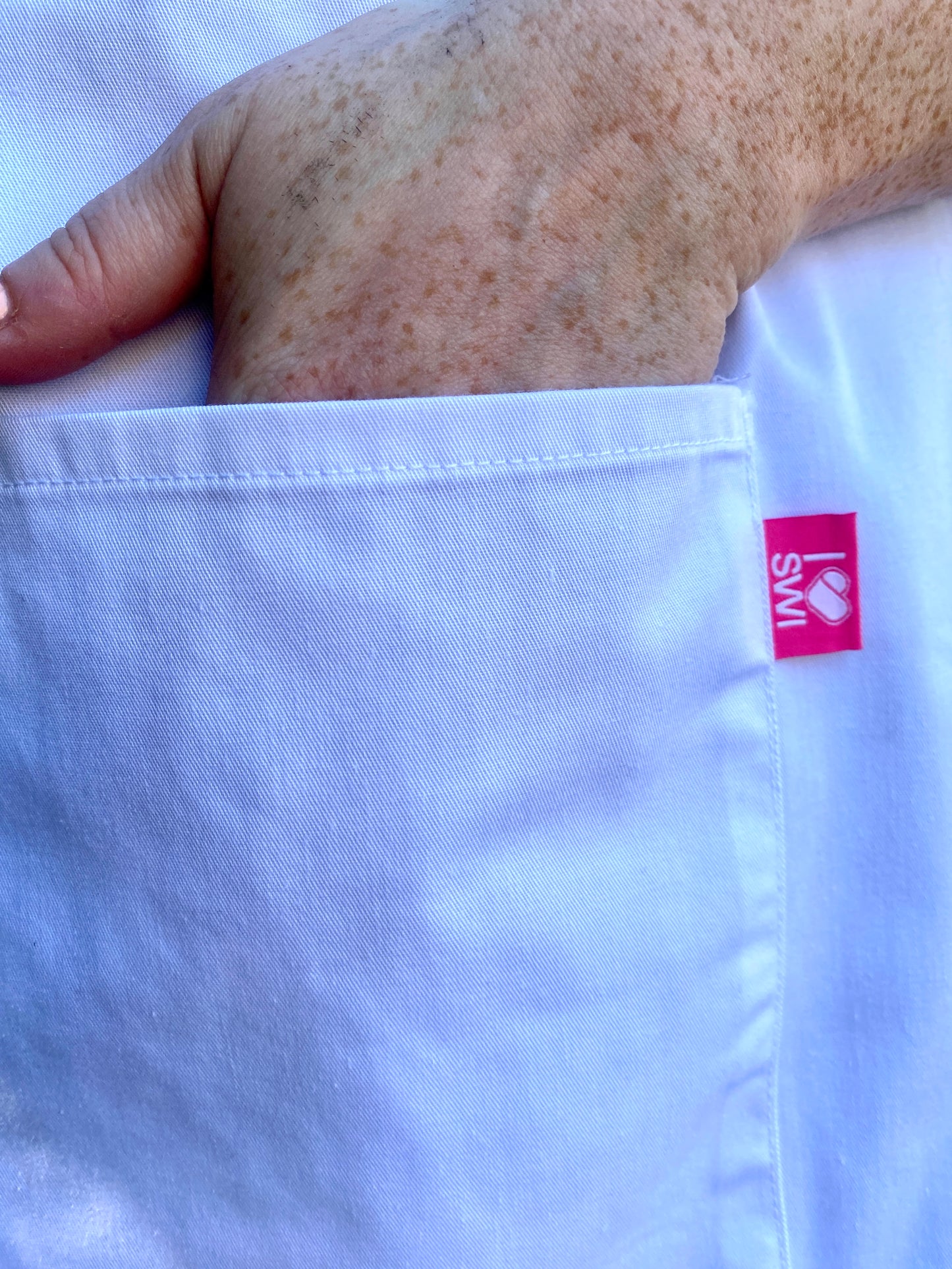 SWI Apron - White with pink SWI label (single item)
